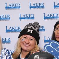 Three girls holding laker gear